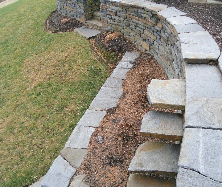 Curved stone wall with cantalever steps